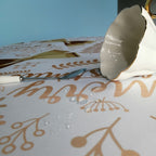 60" x 84" Rectangle Christmas Ribbon & Leaf Print Polyester Wipe Clean Tablecloth - White & Gold