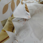 60" x 84" Rectangle Christmas Ribbon & Leaf Print Polyester Wipe Clean Tablecloth - White & Gold