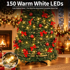 A decorated Christmas tree in a cozy living room setting, lit with warm white LED lights and adorned with red bows and red ornaments. Text at the top reads '150 Warm White LEDs' and 'Cosy Festive Glow | Pre-lit & Pre-decorated Complete Decor Set.