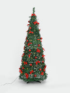 A decorated artificial Christmas tree with green branches, red bows, red ornaments, and small warm white lights, shown on a plain light gray studio background.